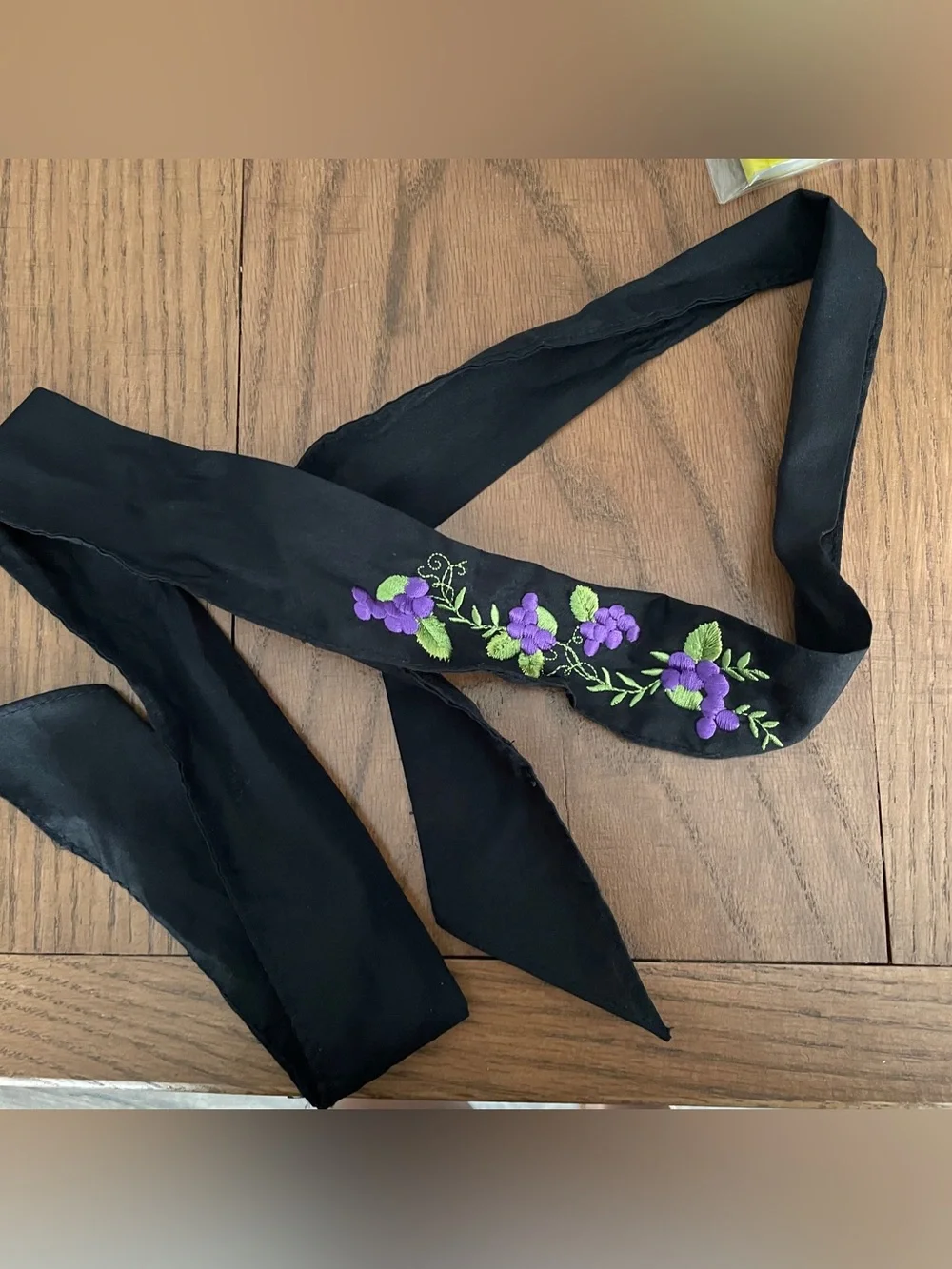 Black cloth hair scarf with purple floral embroidery and green leaves